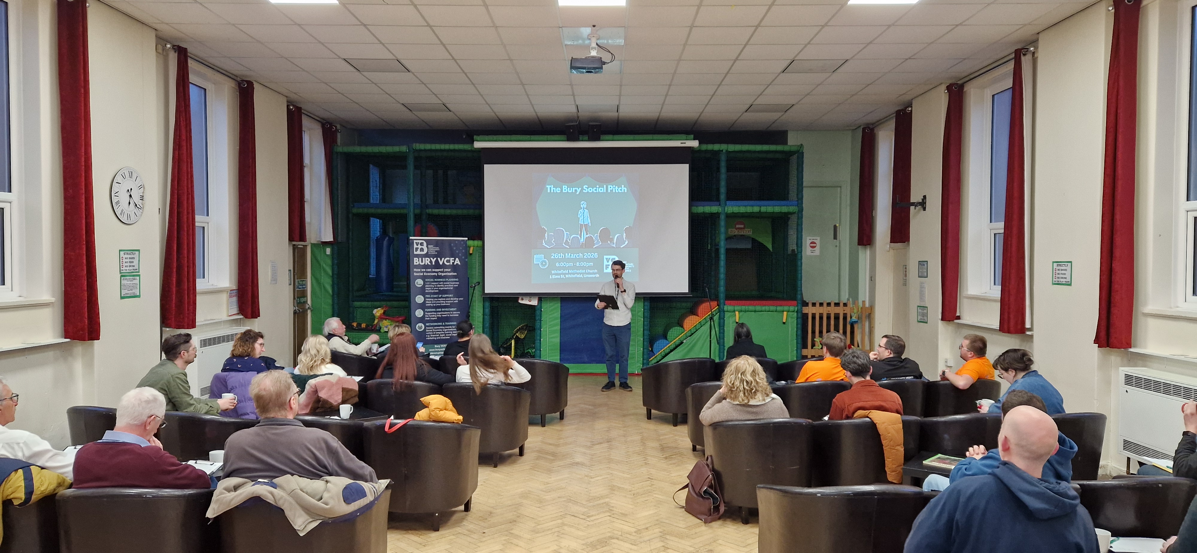 Photo of a man presenting to an audience