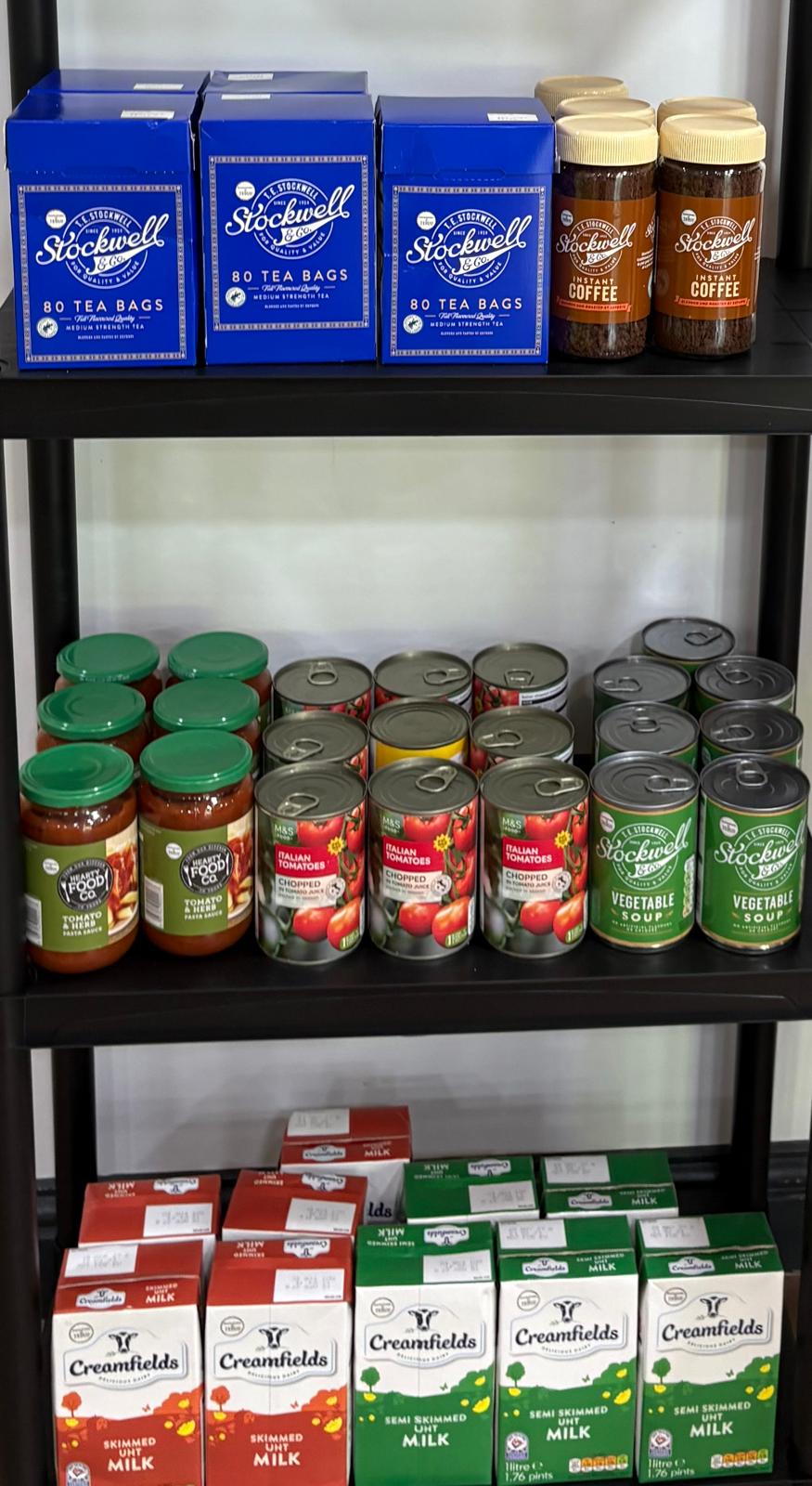 Photo of tinned food on display in an open faced cabinet