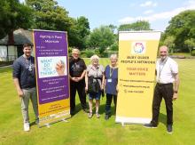Age without Limits group pic - individuals stood with pop up banners