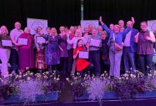 Photograph of Radcliffe Community Groups smiling into the camera, receiving the North West in Bloom award