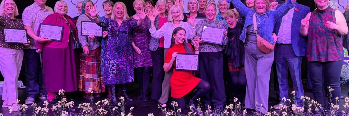 Photograph of Radcliffe Community Groups smiling into the camera, receiving the North West in Bloom award
