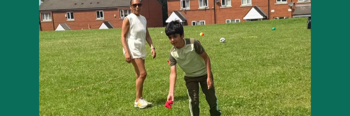 Photo of two people in a grass field
