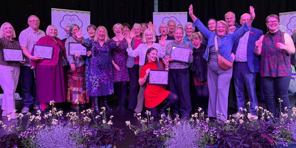 Photograph of Radcliffe Community Groups smiling into the camera, receiving the North West in Bloom award