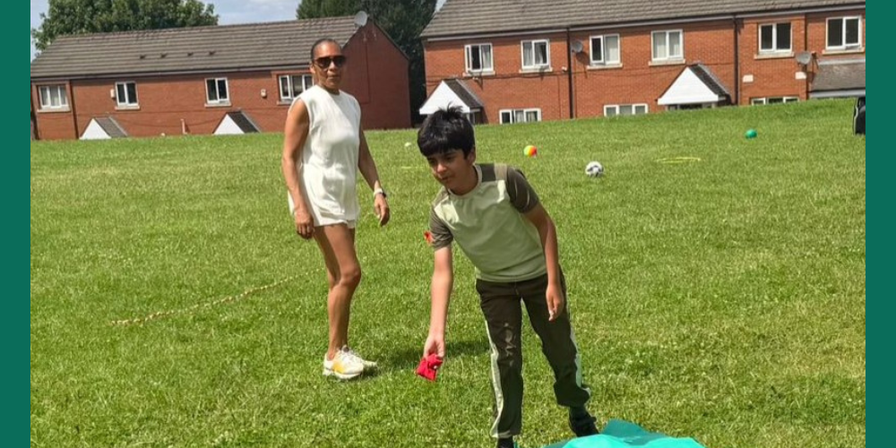 Photo of two people in a grass field