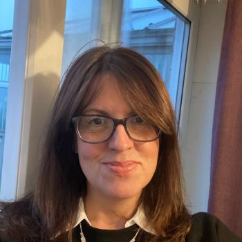 Selfie photo of a woman smiling into the camera.