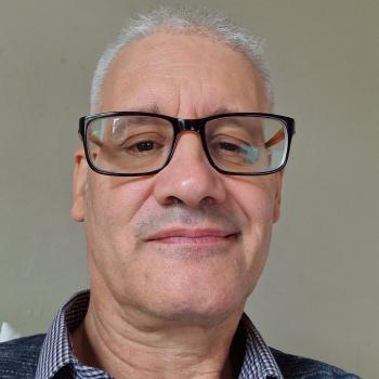 Picture of Tim Bryant - an male wearing glasses and a blur shirt