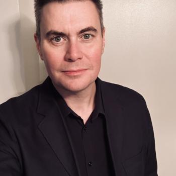 Image of a male smiling in a selfie picture