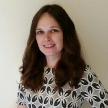 Image of a women smiling into the camera